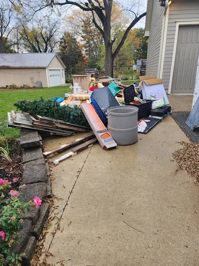 Dumpster being loaded with debris for Roofing Dumpster Rental in Maidencreek